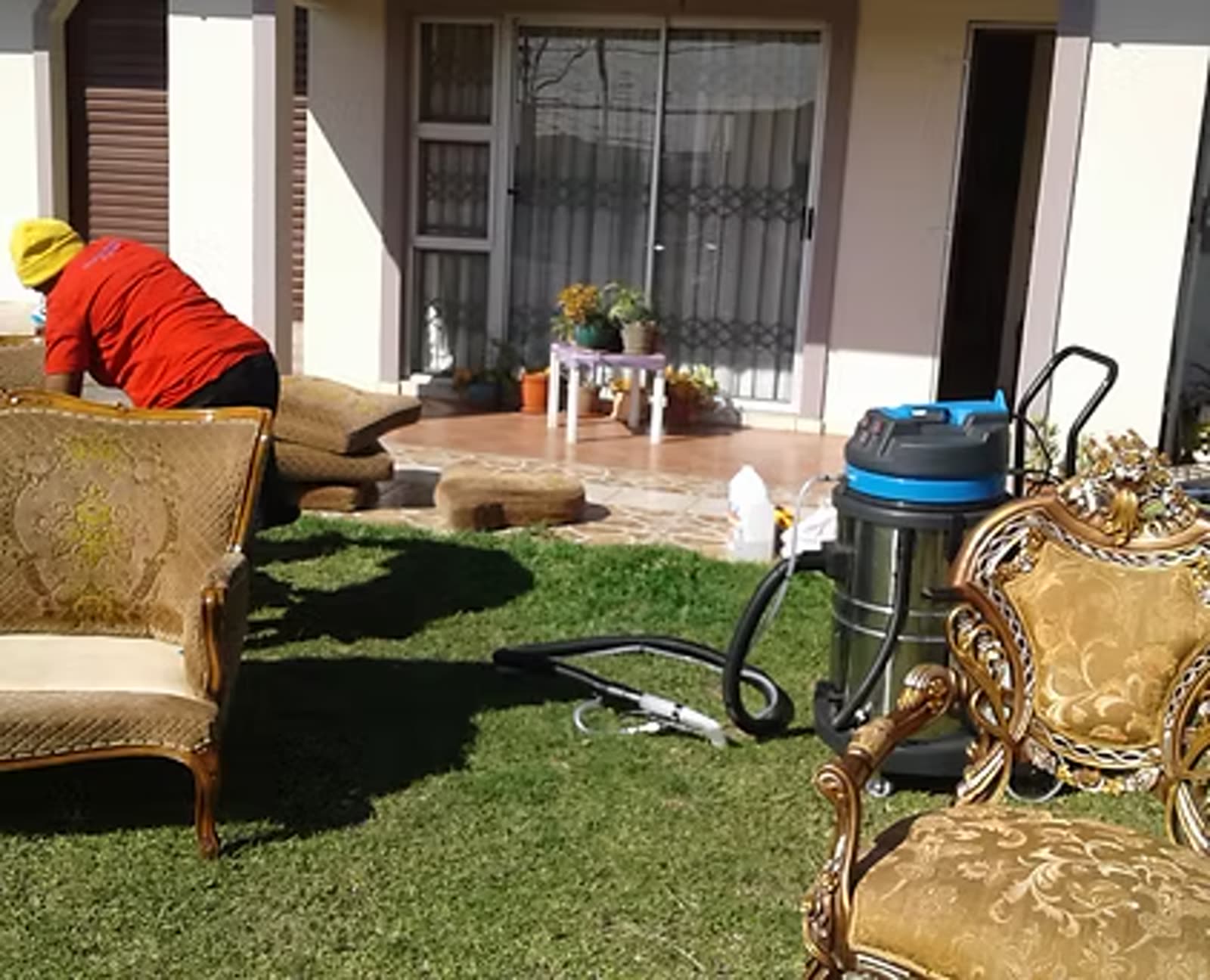 Mizo Hygiene Services team cleaning upholstered lounge suites with professional extraction equipment